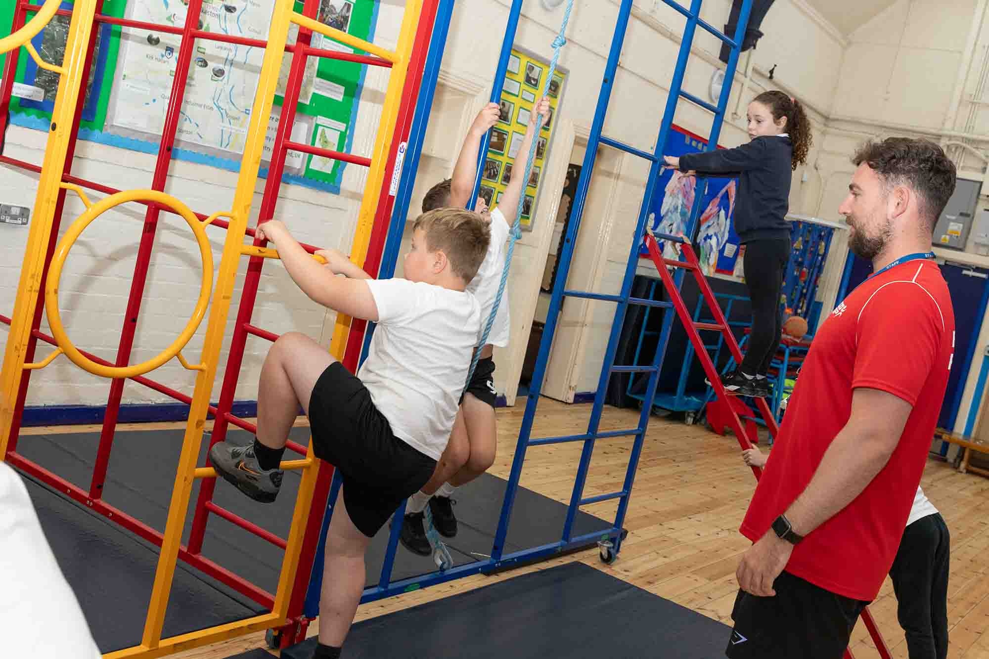 Children playing on inside gym equipment